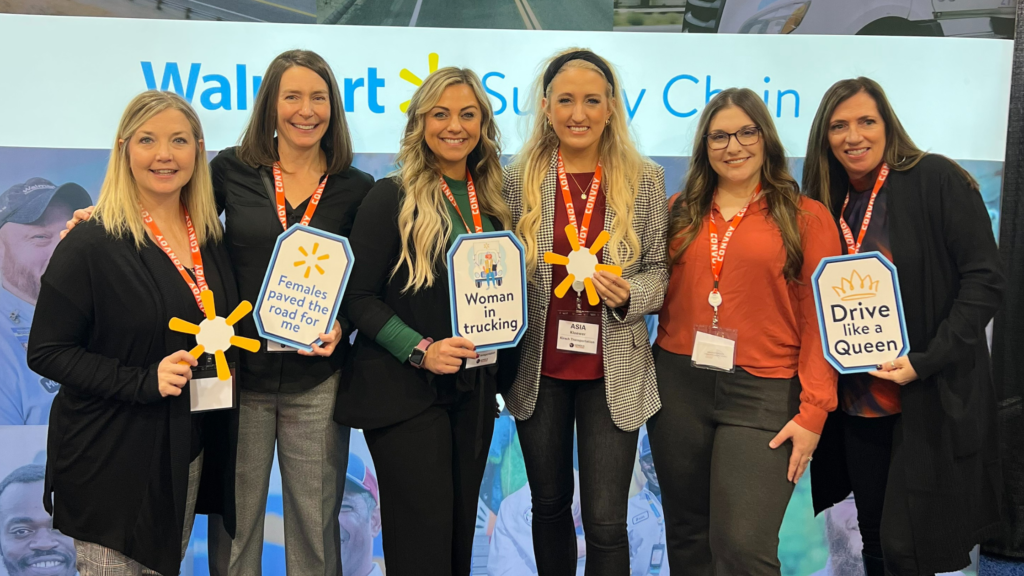 Six women dressed professionally at a women in trucking conference.